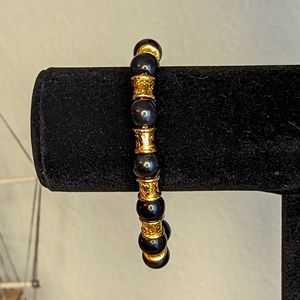 Liz Claiborne (LCI) Black and gold tone bracelet